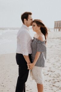 Man and woman standing close to each other on beach
