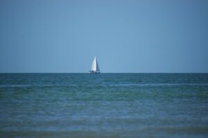 sailboat on a journey far off at sea